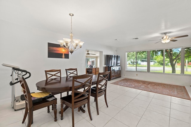 tiled dining area with ceiling fan with notable chandelier