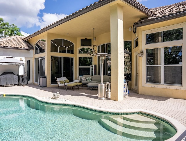 rear view of property featuring a patio and an outdoor hangout area