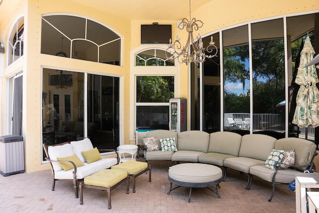 sunroom featuring an inviting chandelier