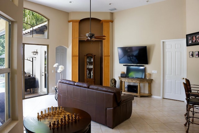 kitchen with tasteful backsplash, kitchen peninsula, stainless steel fridge, and light tile patterned floors