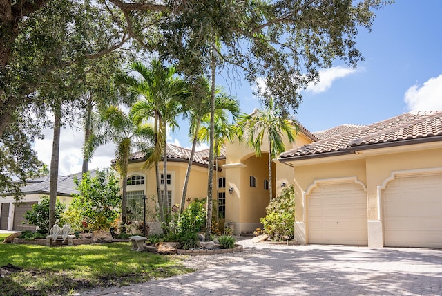 mediterranean / spanish house featuring a garage