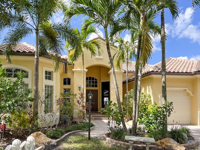 mediterranean / spanish house with a garage