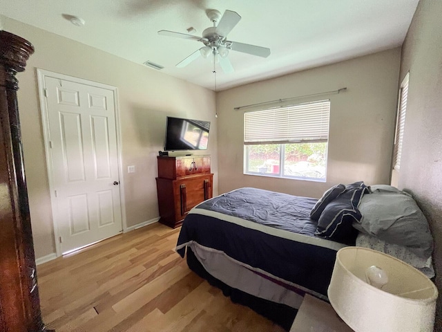 bedroom with ceiling fan and light wood-type flooring