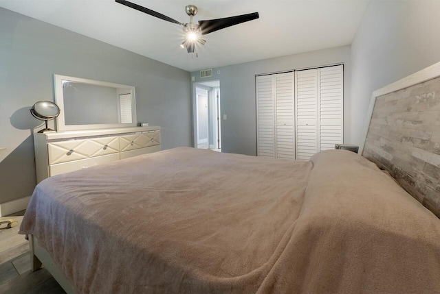 bedroom with ceiling fan and a closet