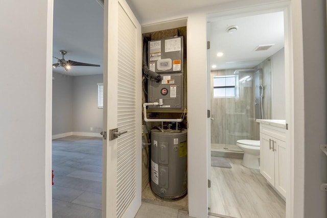 utility room featuring electric water heater and heating unit