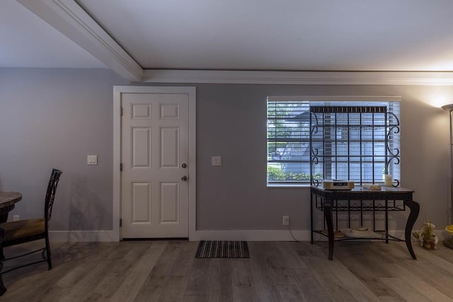 foyer entrance with hardwood / wood-style floors and ornamental molding