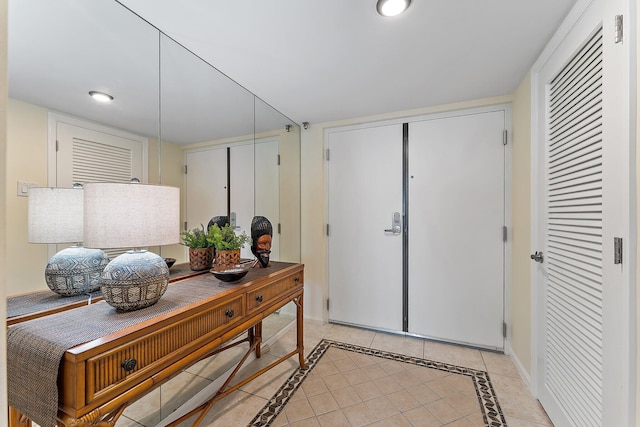 entryway featuring light tile patterned floors, baseboards, and recessed lighting