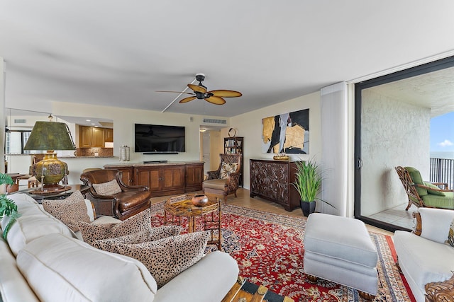 living room with a ceiling fan and light wood-style floors