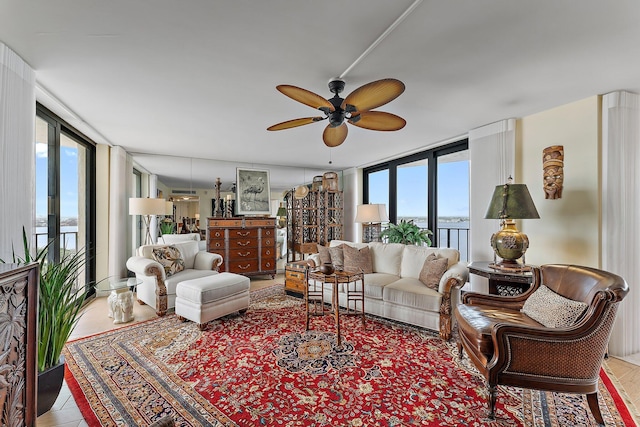 living area featuring expansive windows and ceiling fan