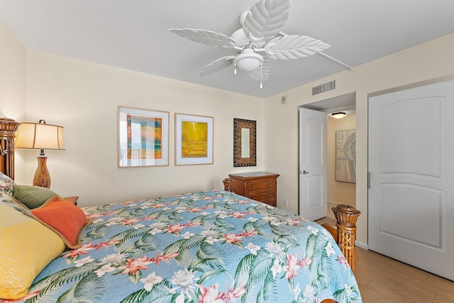 bedroom with ceiling fan, light wood-type flooring, and visible vents