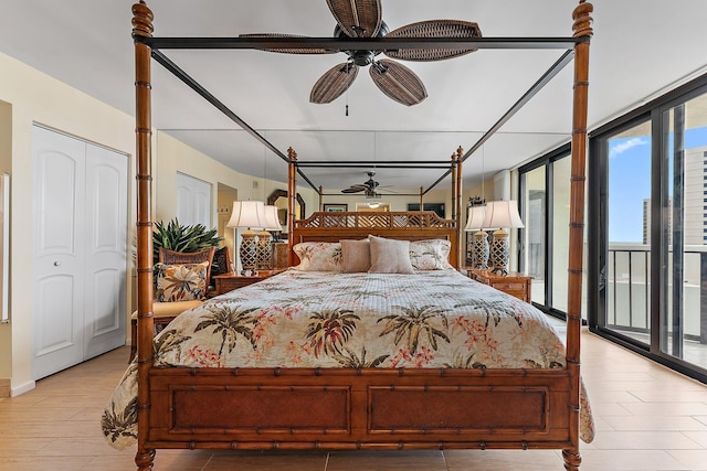 bedroom featuring access to exterior, ceiling fan, floor to ceiling windows, and light wood finished floors