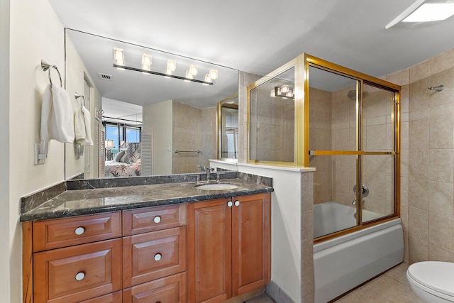 full bath featuring visible vents, toilet, enclosed tub / shower combo, vanity, and tile patterned floors