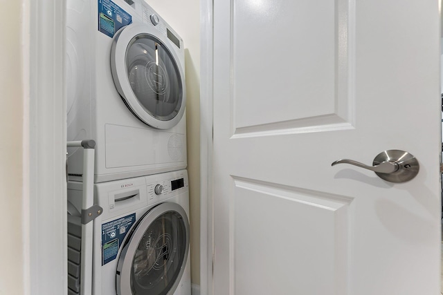 washroom with stacked washer / drying machine