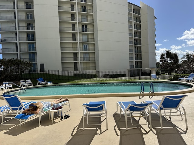 view of pool featuring fence