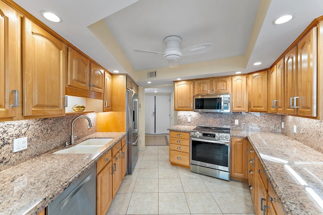 kitchen with light stone counters, light tile patterned floors, visible vents, appliances with stainless steel finishes, and a sink