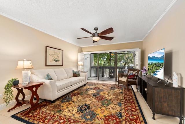 living room featuring ceiling fan, crown molding, light tile patterned flooring, and a textured ceiling