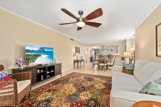 tiled living room with ornamental molding, ceiling fan, and a textured ceiling