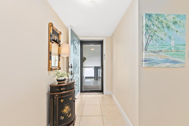 doorway to outside featuring light tile patterned flooring