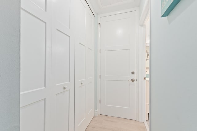 hallway with light hardwood / wood-style flooring