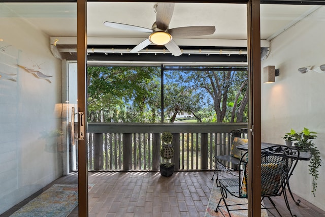 sunroom featuring ceiling fan