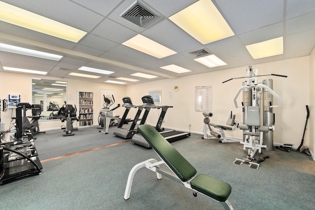 gym with a paneled ceiling