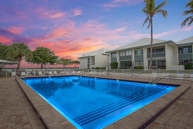 view of pool at dusk