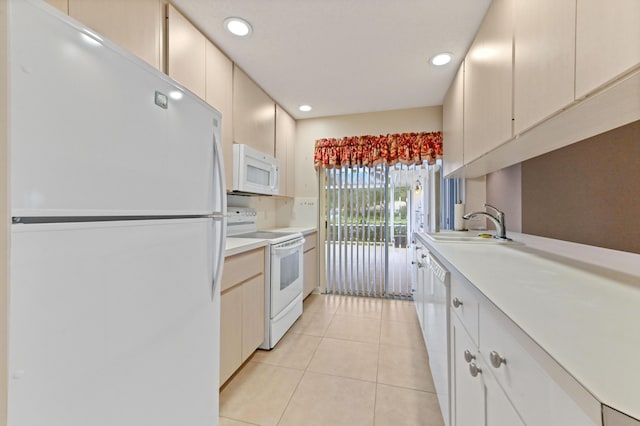 kitchen featuring decorative backsplash, white appliances, sink, white cabinets, and light tile patterned flooring