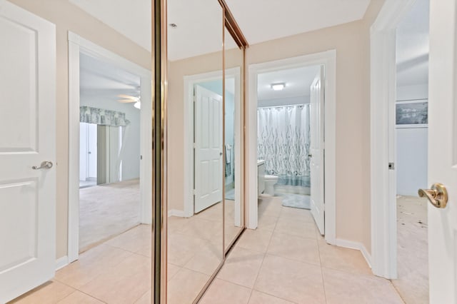 hallway featuring light colored carpet