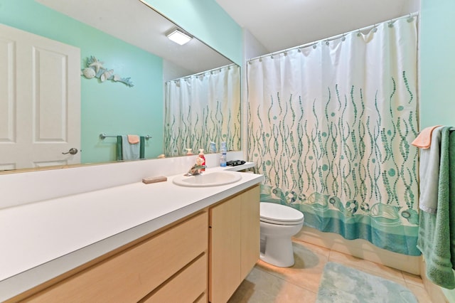 full bathroom featuring tile patterned flooring, vanity, toilet, and shower / bath combo with shower curtain