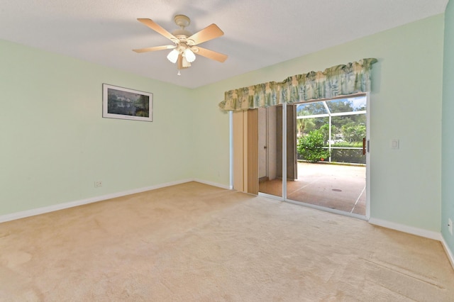 empty room with light colored carpet and ceiling fan