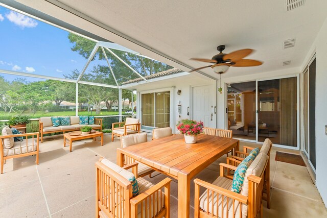 view of front of property with glass enclosure and a front lawn