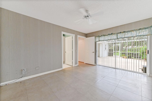 spare room featuring ceiling fan and a textured ceiling