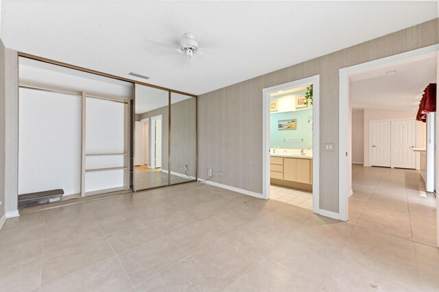 bathroom featuring tile patterned floors, vanity, toilet, and a shower with door