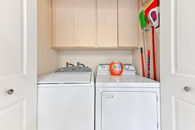 laundry area featuring cabinets and washer and clothes dryer