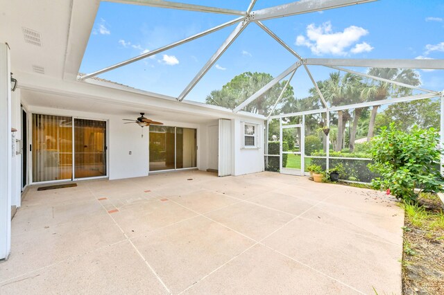 unfurnished sunroom featuring ceiling fan and vaulted ceiling