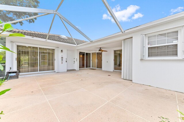 unfurnished sunroom featuring ceiling fan