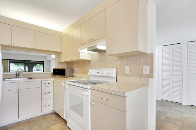 kitchen featuring white appliances, cream cabinets, sink, and tasteful backsplash