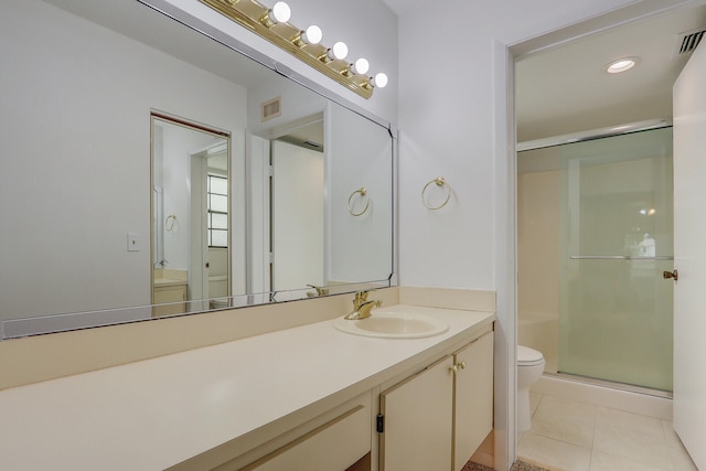 bathroom featuring walk in shower, vanity, tile patterned flooring, and toilet