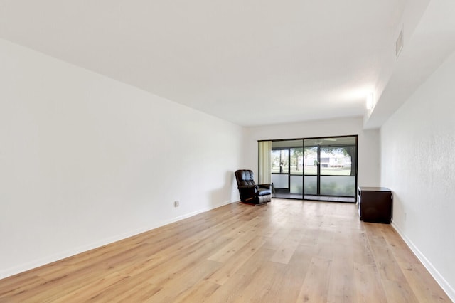 spare room with light hardwood / wood-style flooring