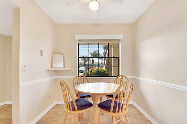 tiled dining space with ceiling fan