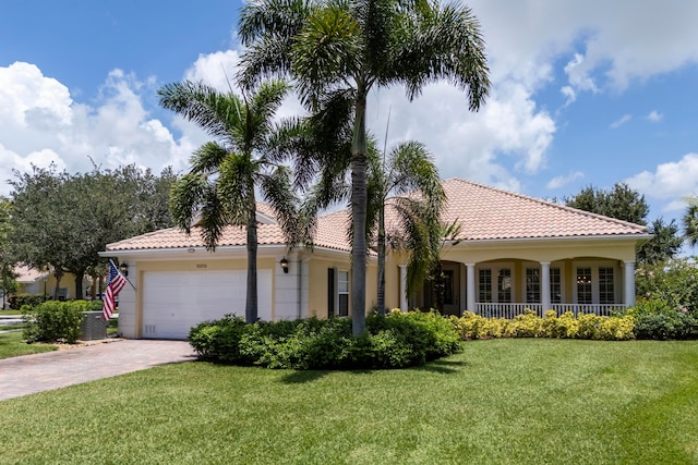 mediterranean / spanish home with a front yard and a garage