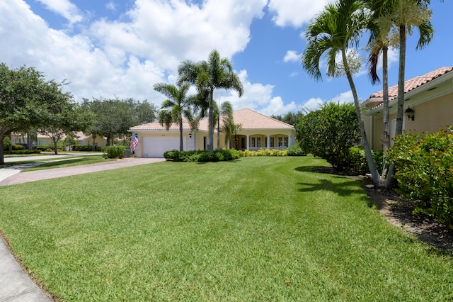 view of front of house featuring a garage and a front lawn