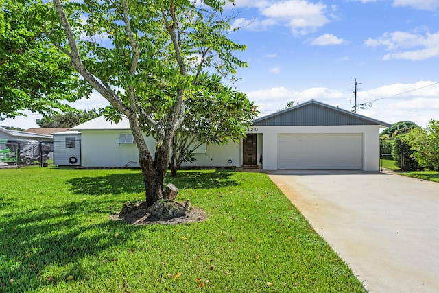 ranch-style home featuring a garage and a front lawn