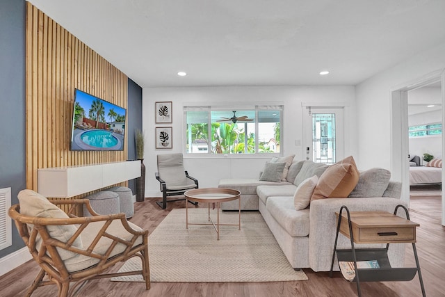 living room featuring ceiling fan and light wood-type flooring