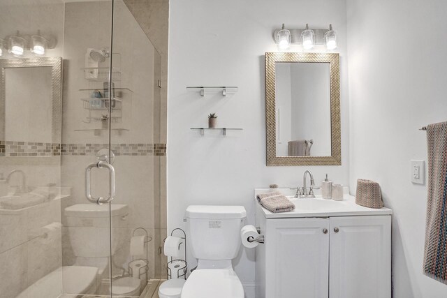 bathroom with vanity, toilet, and a shower with shower door