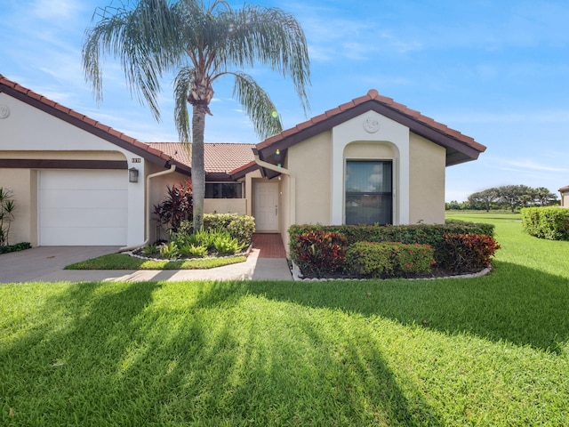 view of front of property featuring a garage and a front lawn