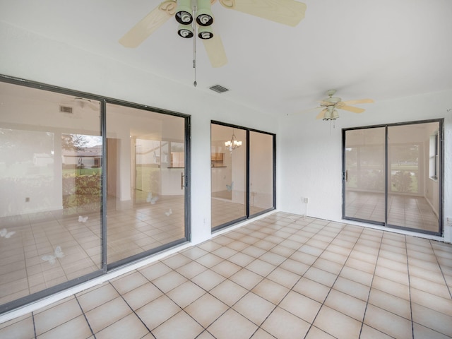 interior space with ceiling fan with notable chandelier