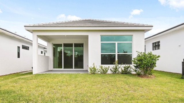 rear view of property featuring a yard