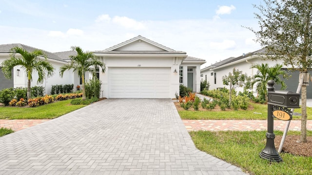 ranch-style house with a garage and a front lawn