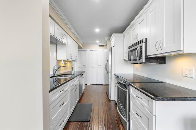 kitchen with dark hardwood / wood-style floors, sink, white cabinetry, stainless steel appliances, and crown molding